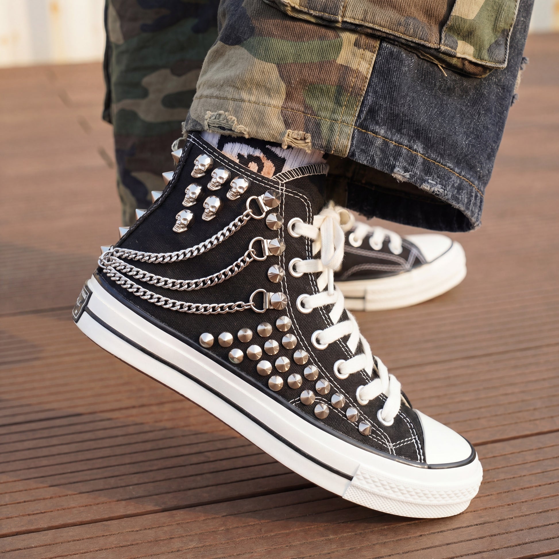 Custom black Converse high top shoes with metal studs and white laces