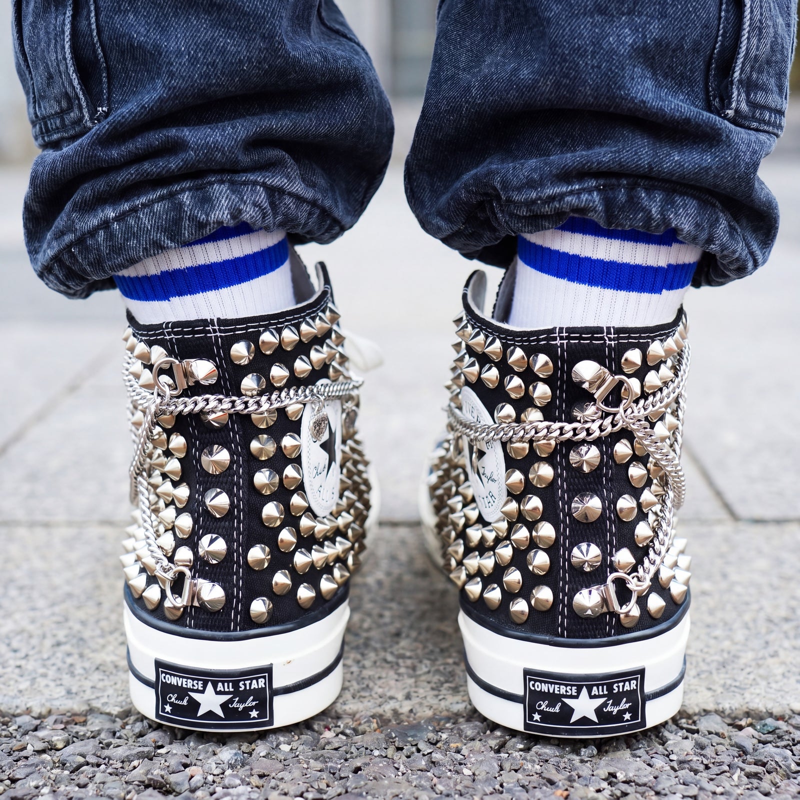 Black Converse high top sneakers with silver chains and studded embellishments