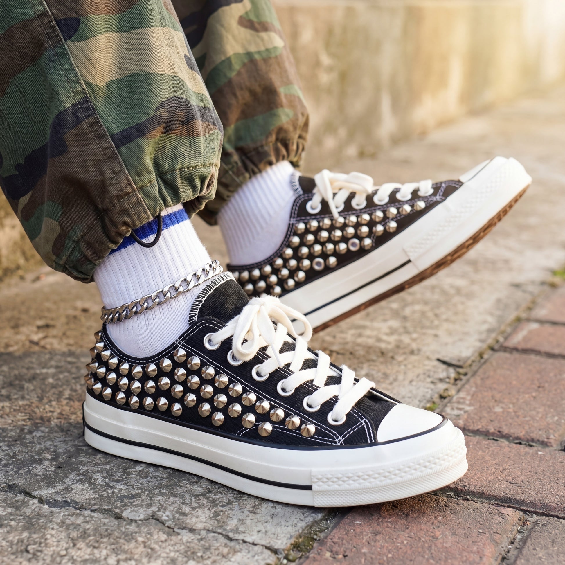 Edgy black Converse low top sneakers with metal spike details