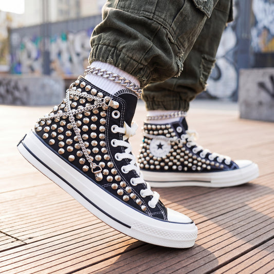 Black studded high top Converse sneakers with silver chains