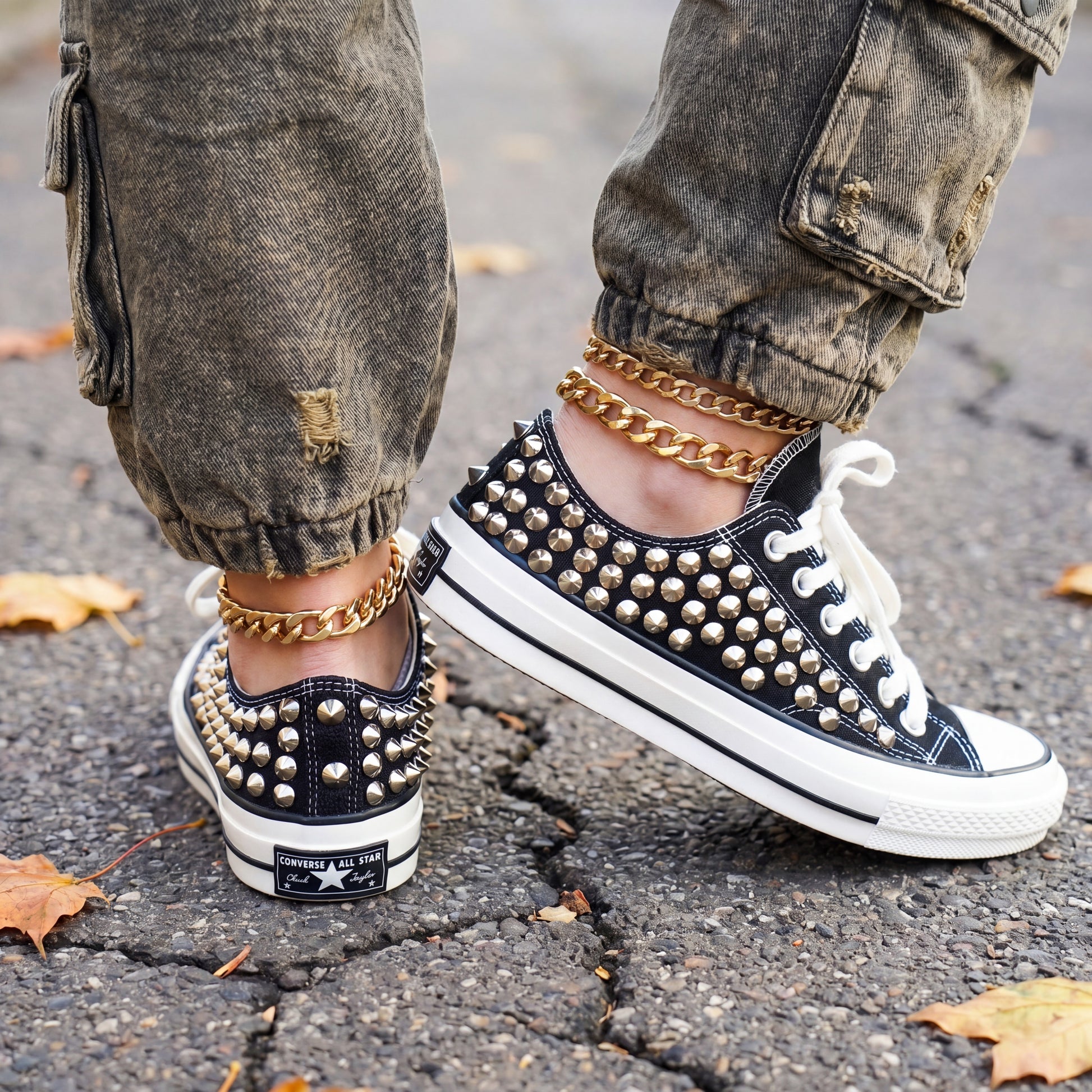 Custom studded low top Converse sneakers styled with denim jeans