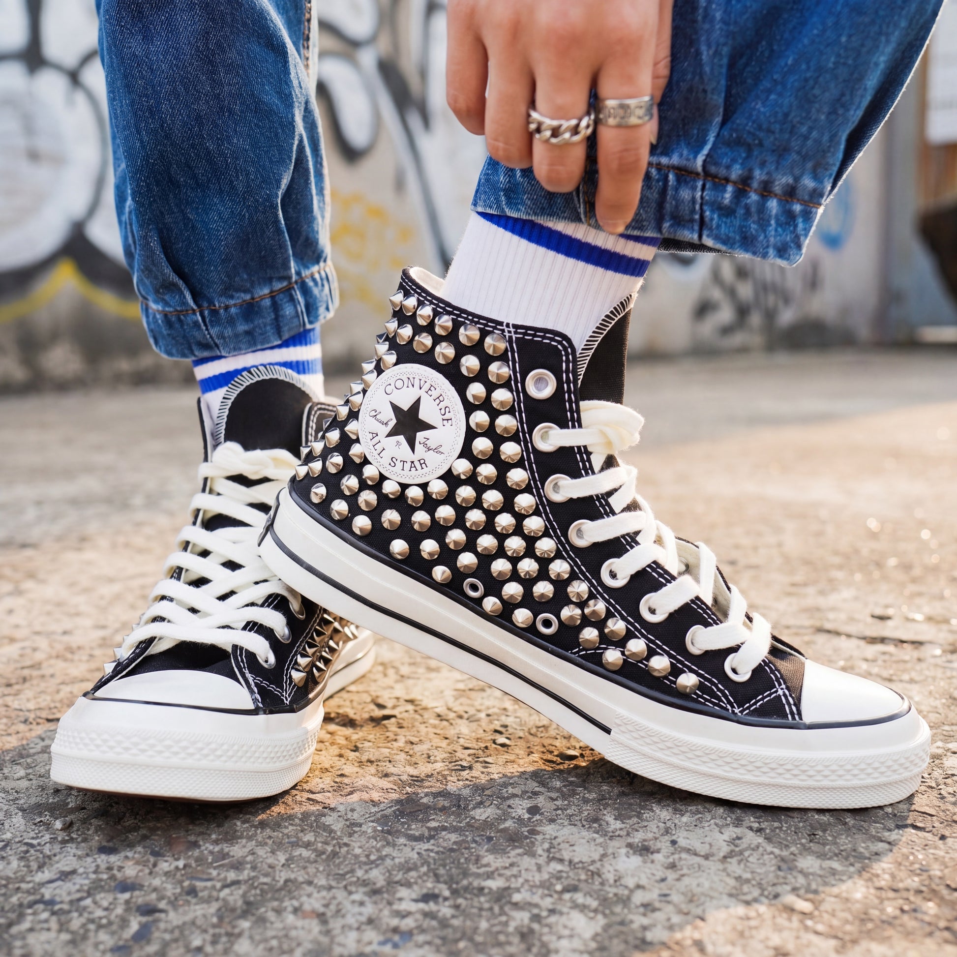 Custom black Converse high top shoes with metal studs and white laces