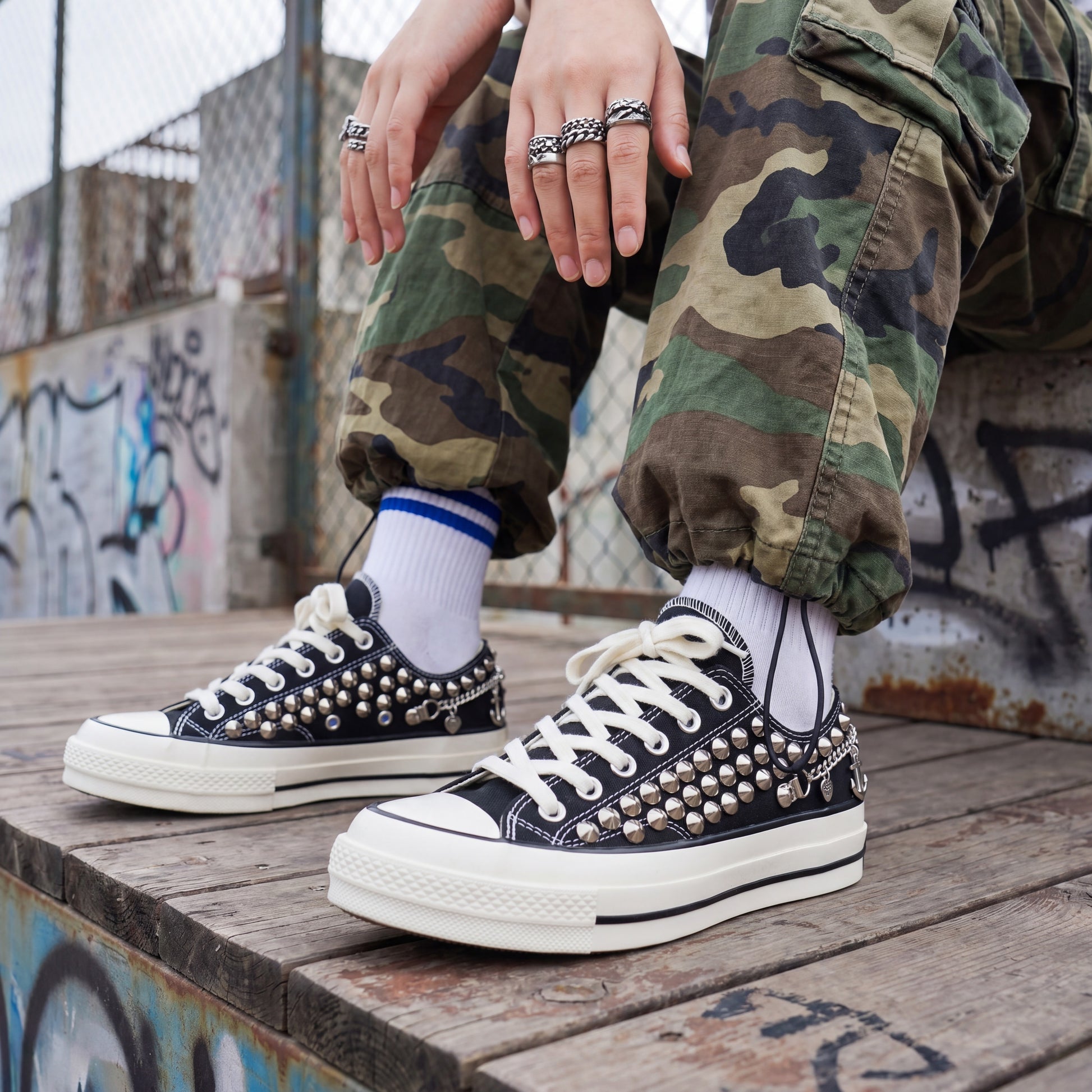 Punk rock black Converse sneakers with silver spikes and anchor details