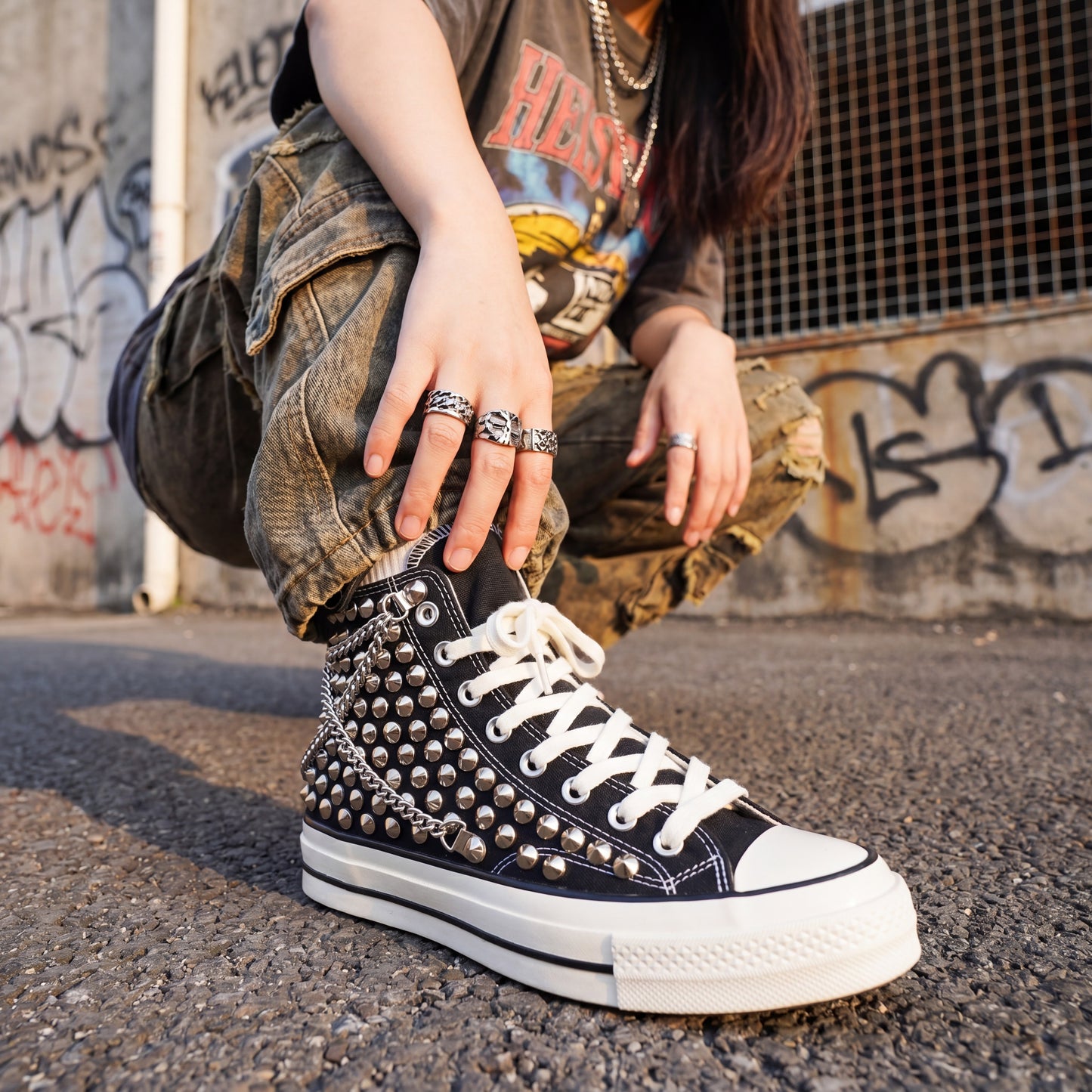 Custom black Converse high top shoes with silver studs and white laces