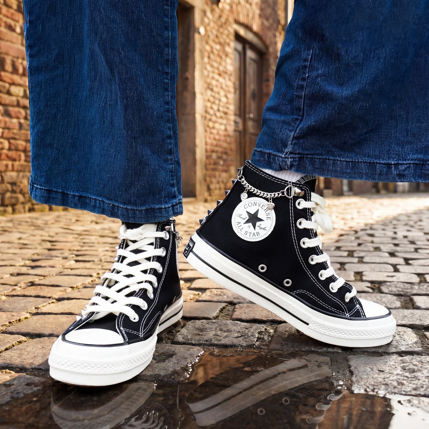 Edgy black Converse high top sneakers with skull charms and metal chains