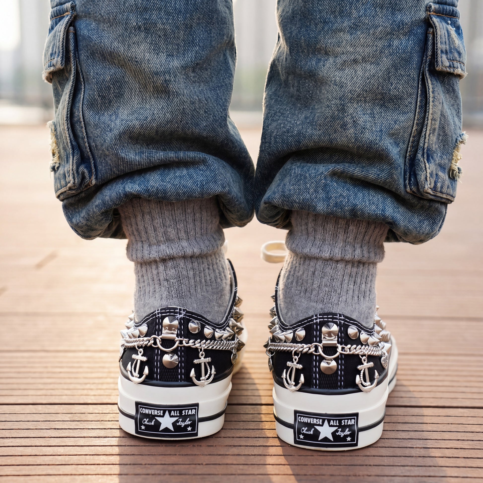 Custom black Converse low top shoes with metal studs and white laces