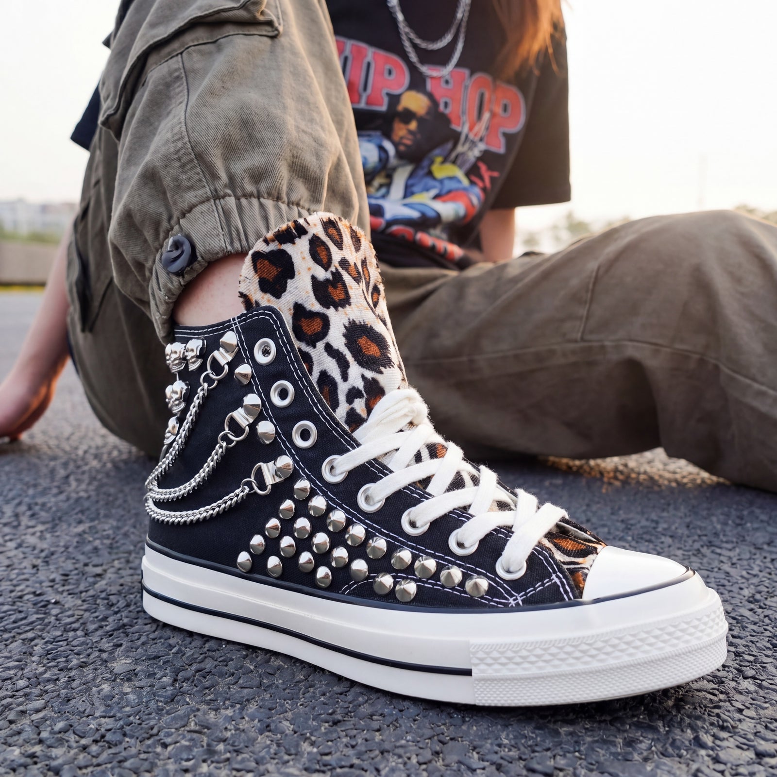 Custom studded high top Converse sneakers styled with cargo pants