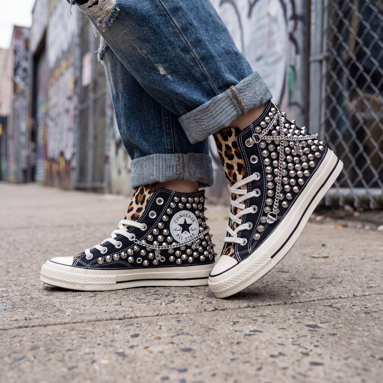 Black studded Converse sneakers with leopard print accents for bold outfits