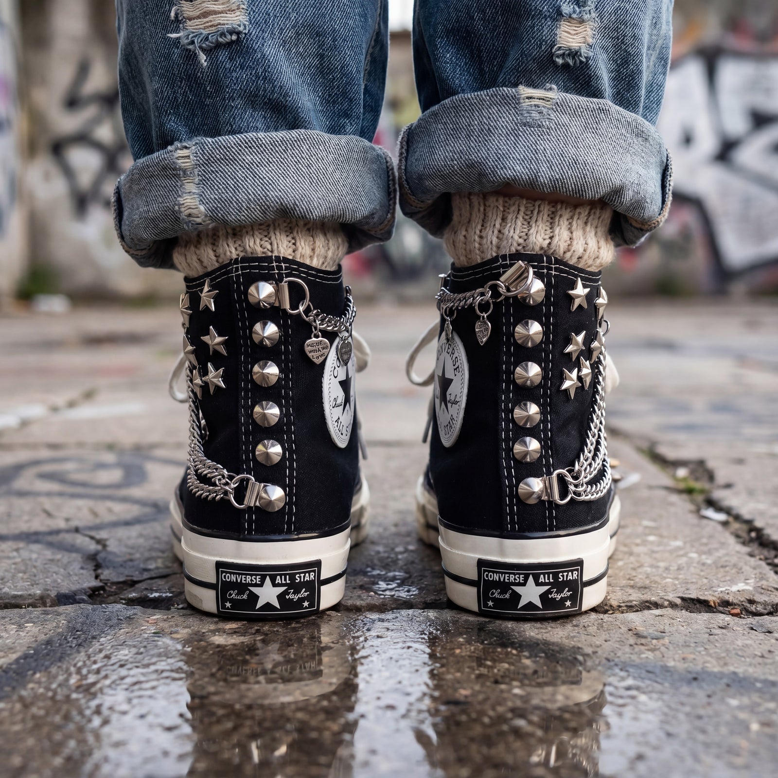 Black Converse high top sneakers with star charms and chain accessories