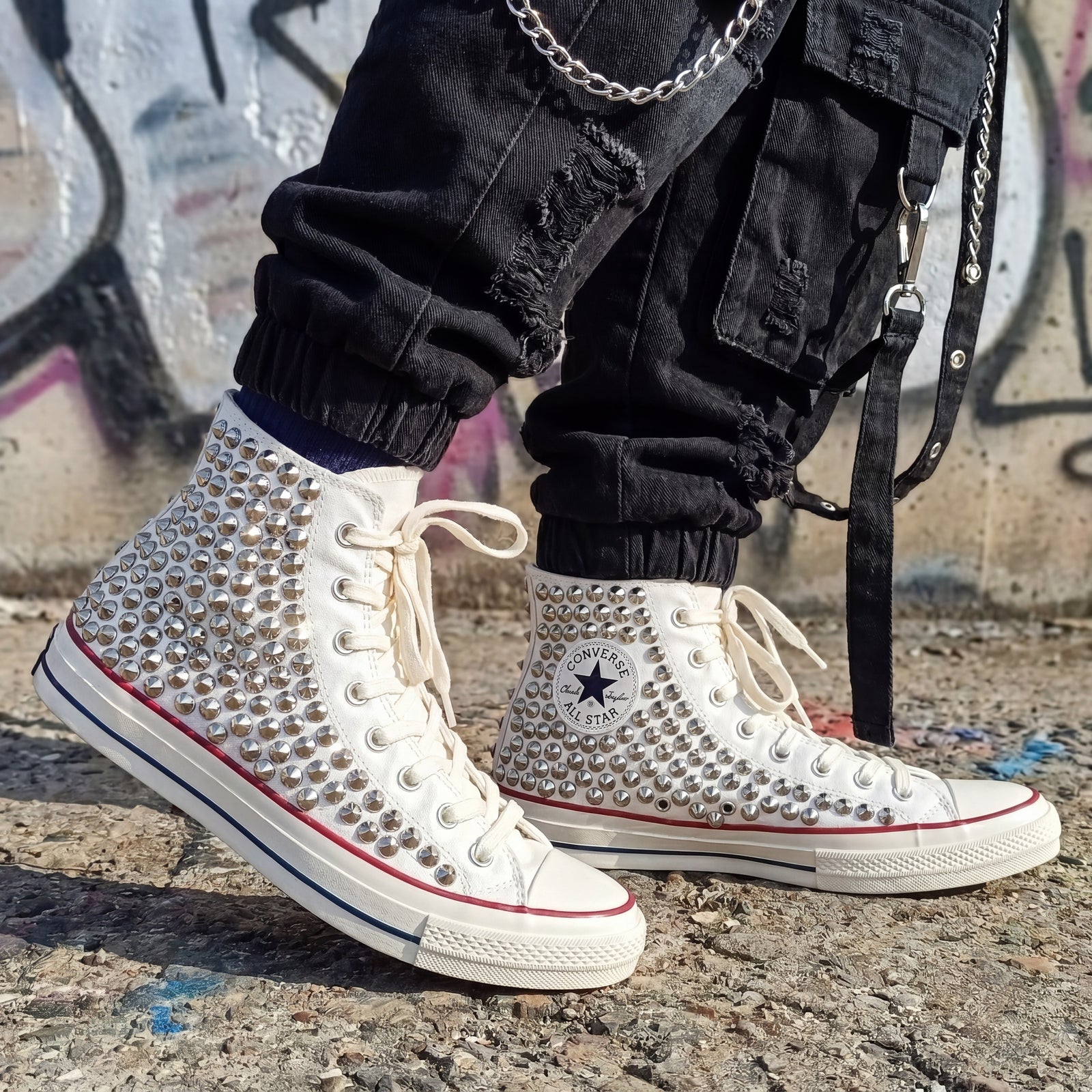 White Converse high top sneakers with silver spike embellishments