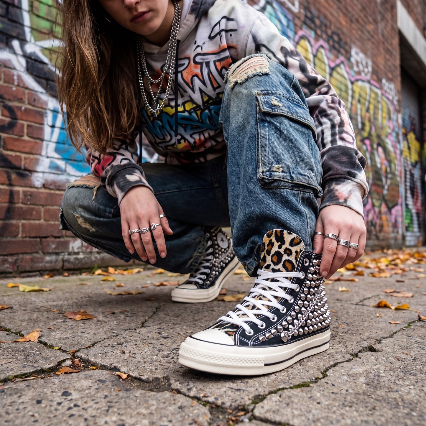 Edgy black Converse high top sneakers with silver hardware and white laces