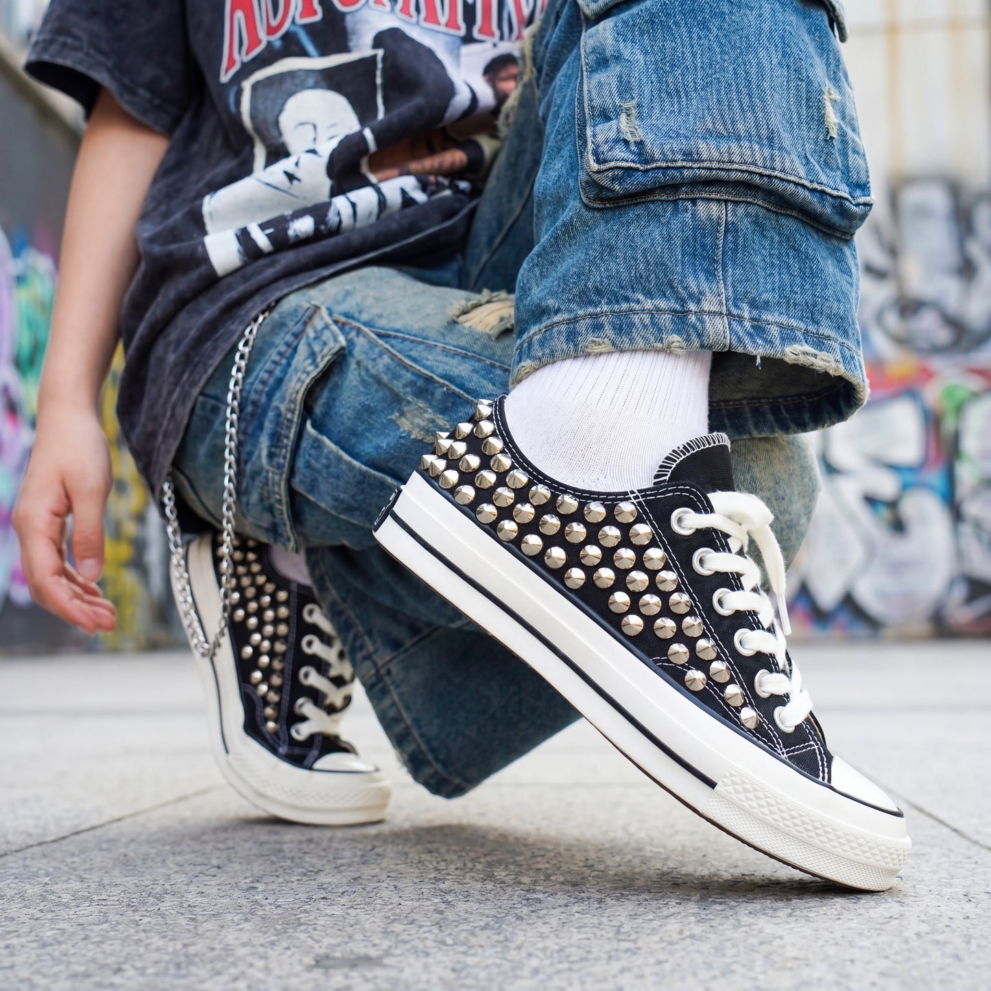 Custom black Converse low top shoes with metal studs and white laces