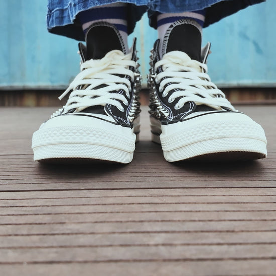 Custom black studded high top sneakers with silver rivets and decorative chains