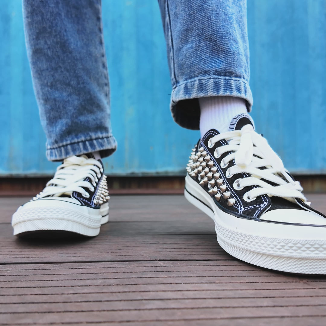 Custom studded Converse low top shoes with metal rivets and white laces