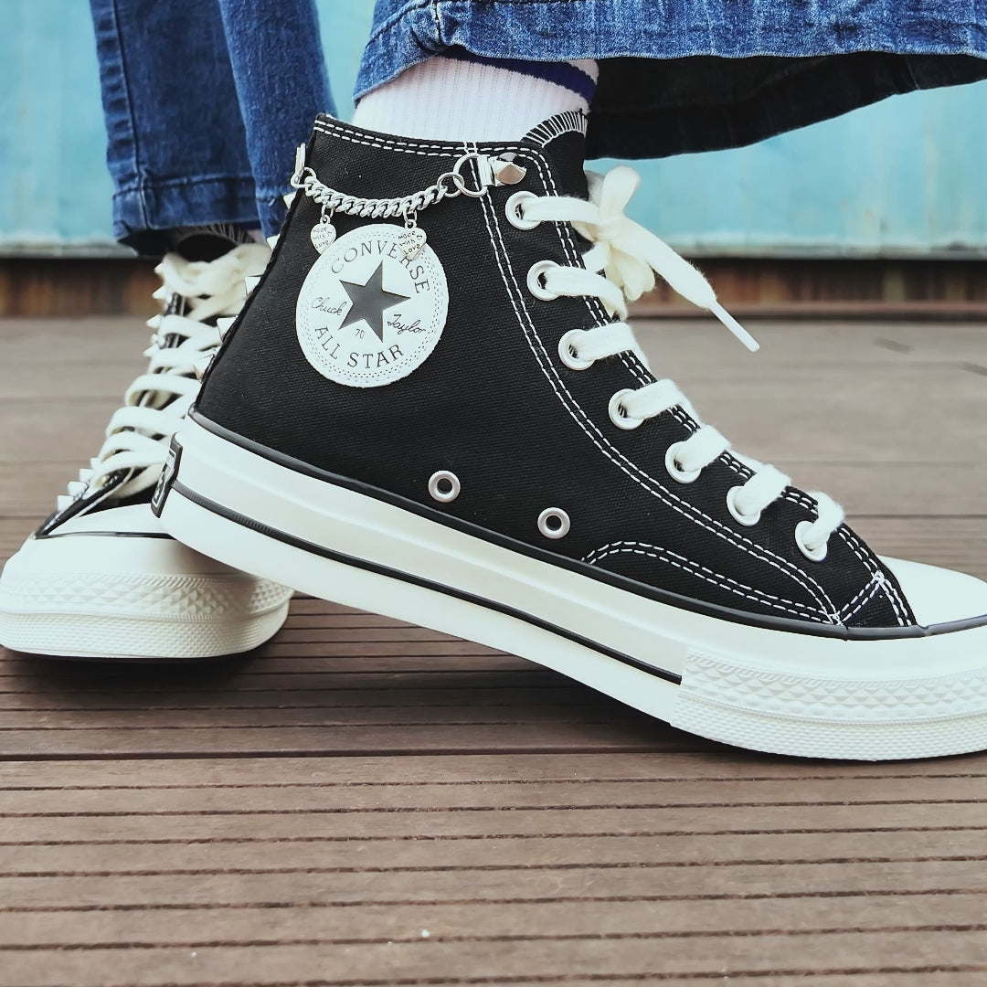 Custom studded Converse high top shoes with metal chains and skull embellishments
