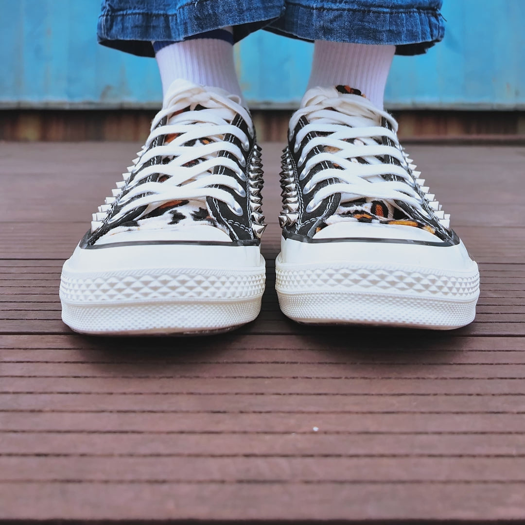 Custom studded Converse low top shoes with metal rivets and animal print accent