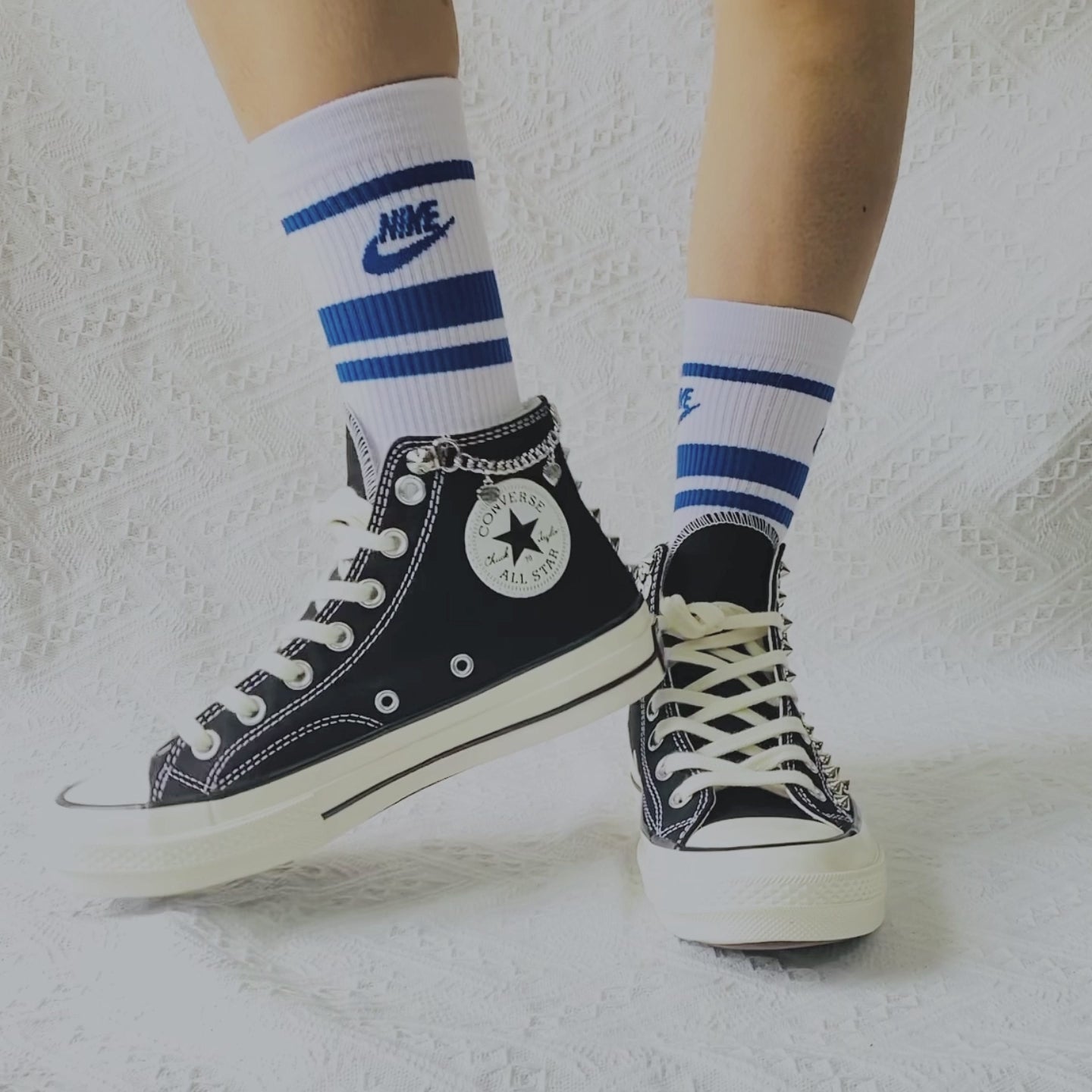 Custom black Converse high top shoes with metal studs and white laces