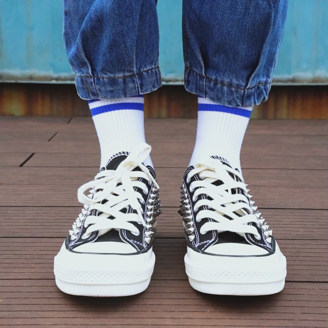 Custom studded Converse style sneakers with metal rivets and anchor charms