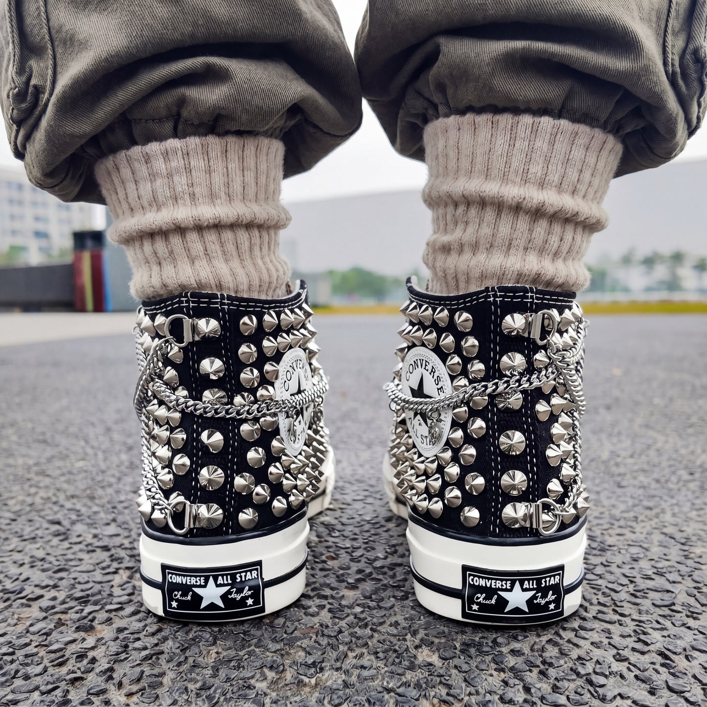 Custom black Converse high top shoes with silver chains and metal studs