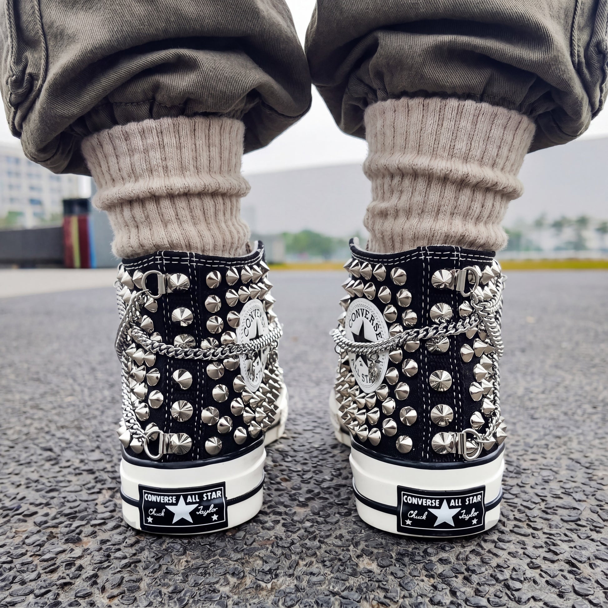 Custom black Converse high top shoes with silver chains and metal studs