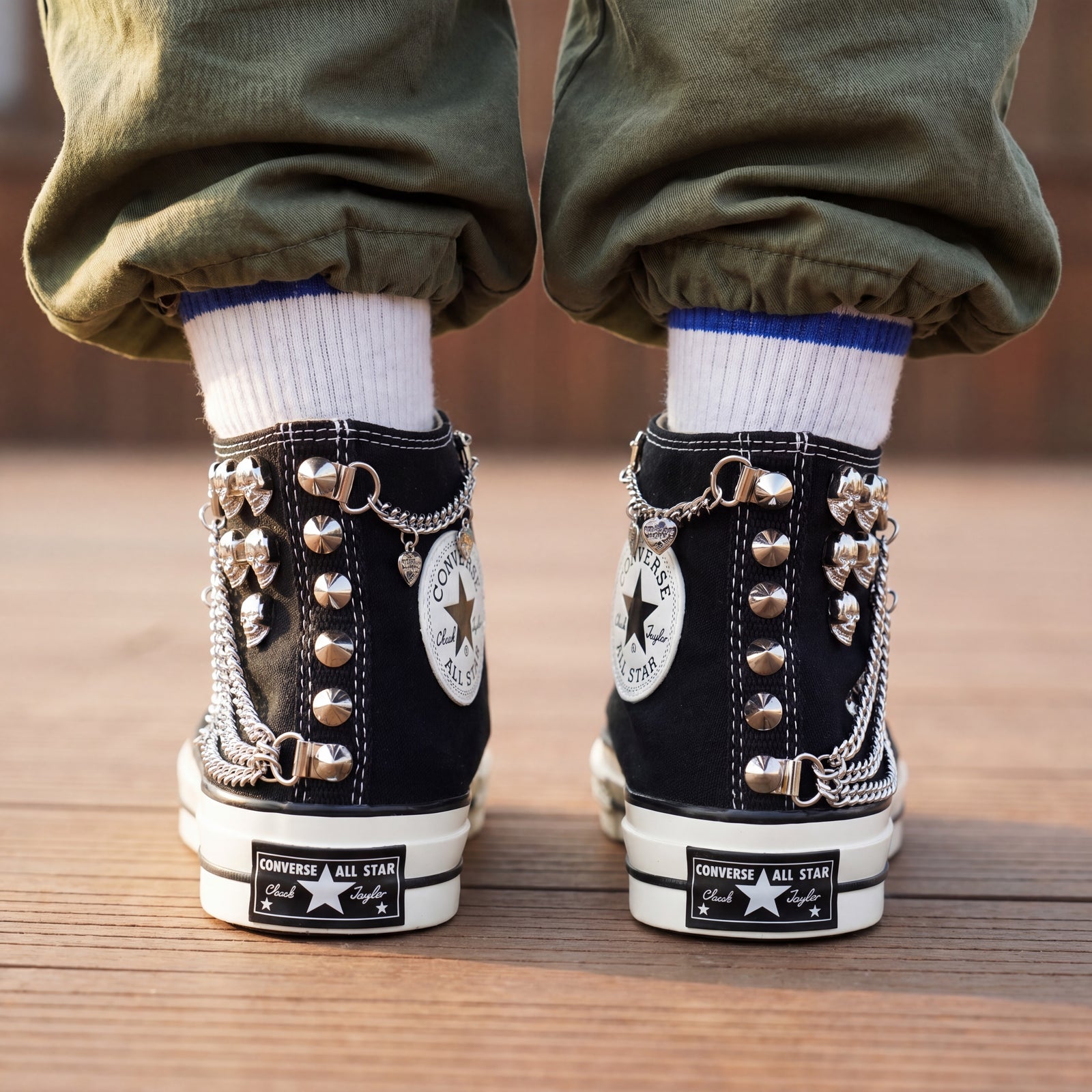 Black Converse high top sneakers with leopard print tongue and chain details