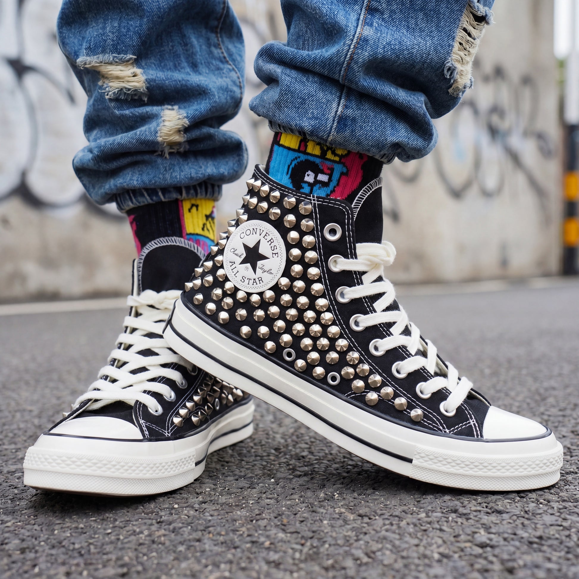 Edgy black Converse high top sneakers with silver hardware details
