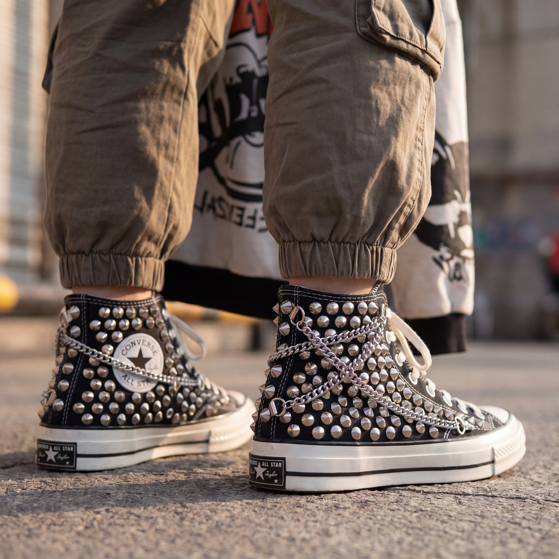 Edgy black Converse high top sneakers with metal studs and white rubber sole