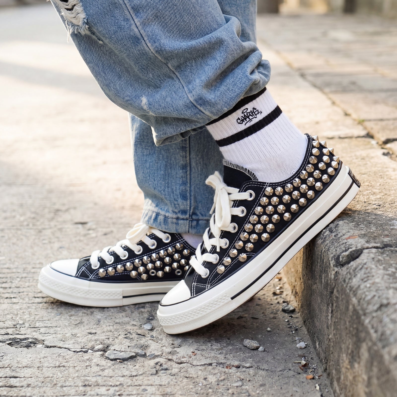 Black studded Converse low top sneakers for punk street style outfits