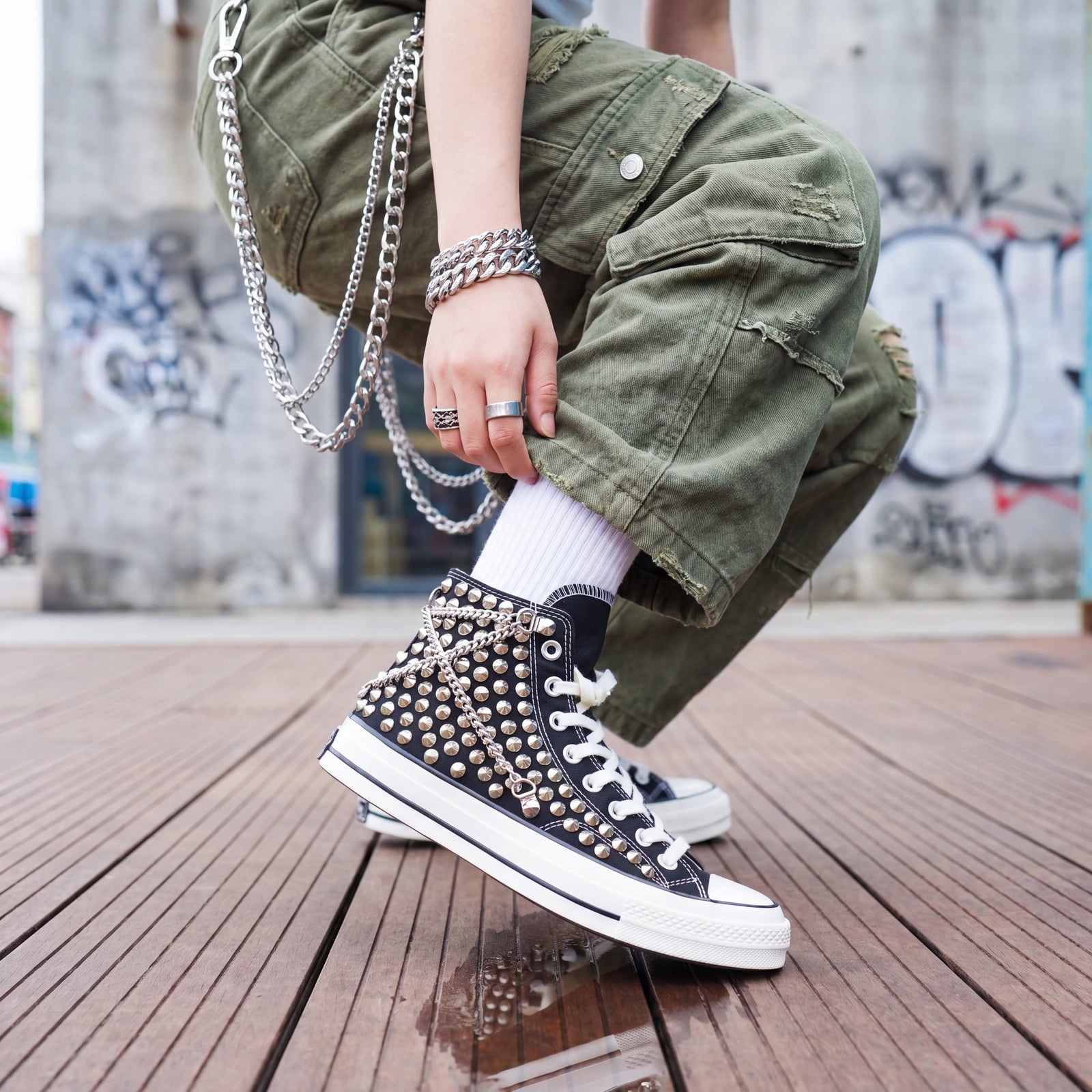 Custom studded high top Converse sneakers styled with cargo pants