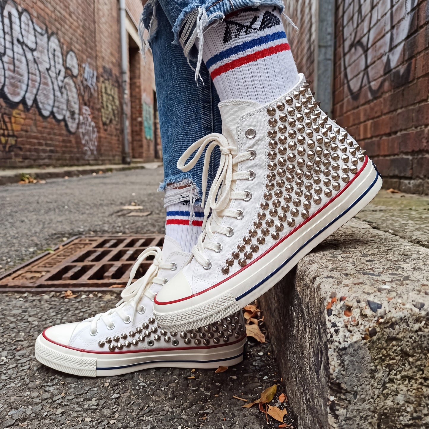 Handmade studded Converse shoes with white canvas and metal hardware
