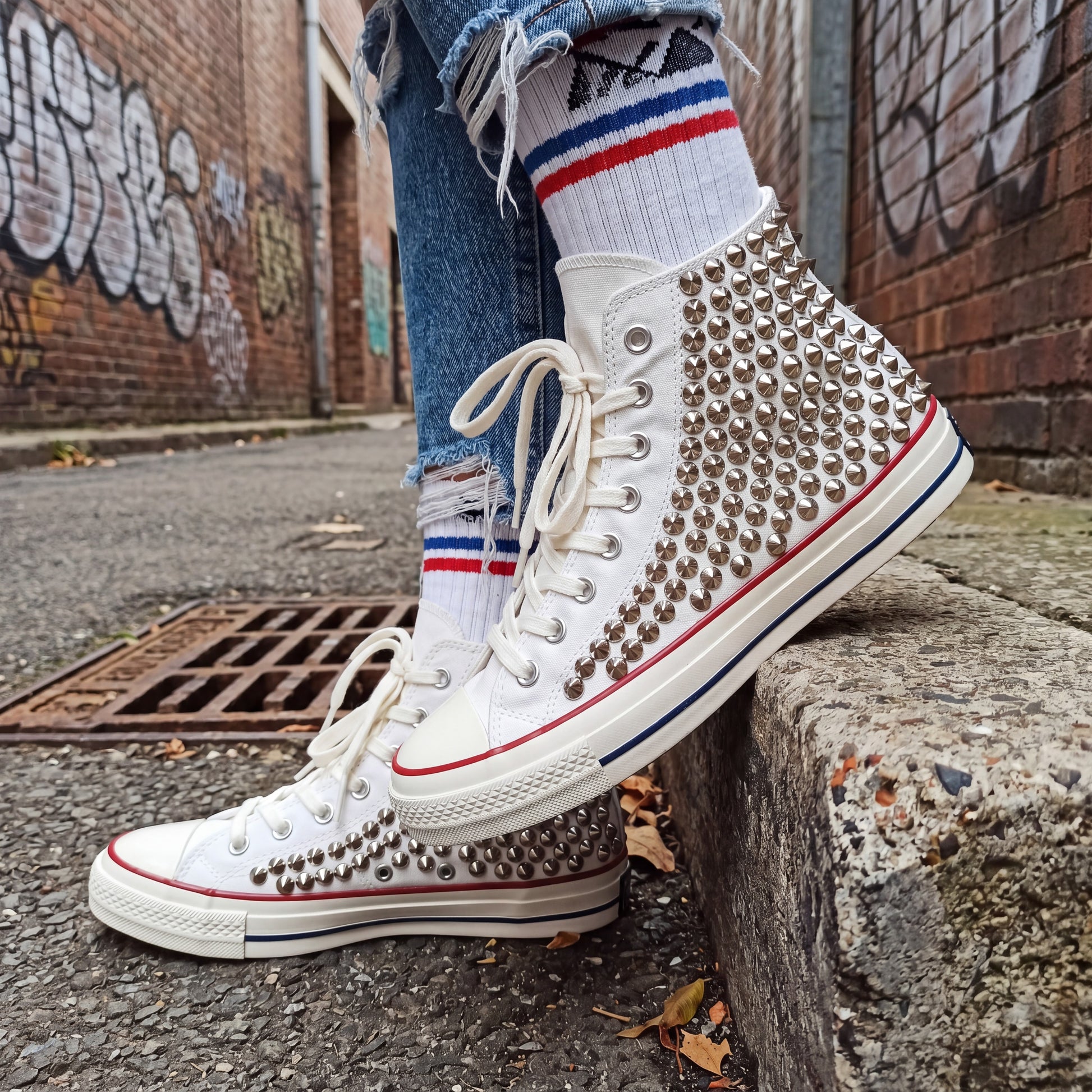 Handmade studded Converse shoes with white canvas and metal hardware