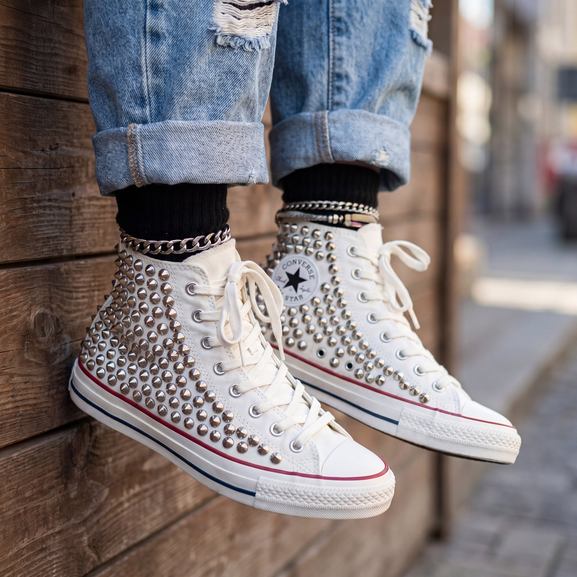 Edgy white high top Converse sneakers with silver studs and rubber sole