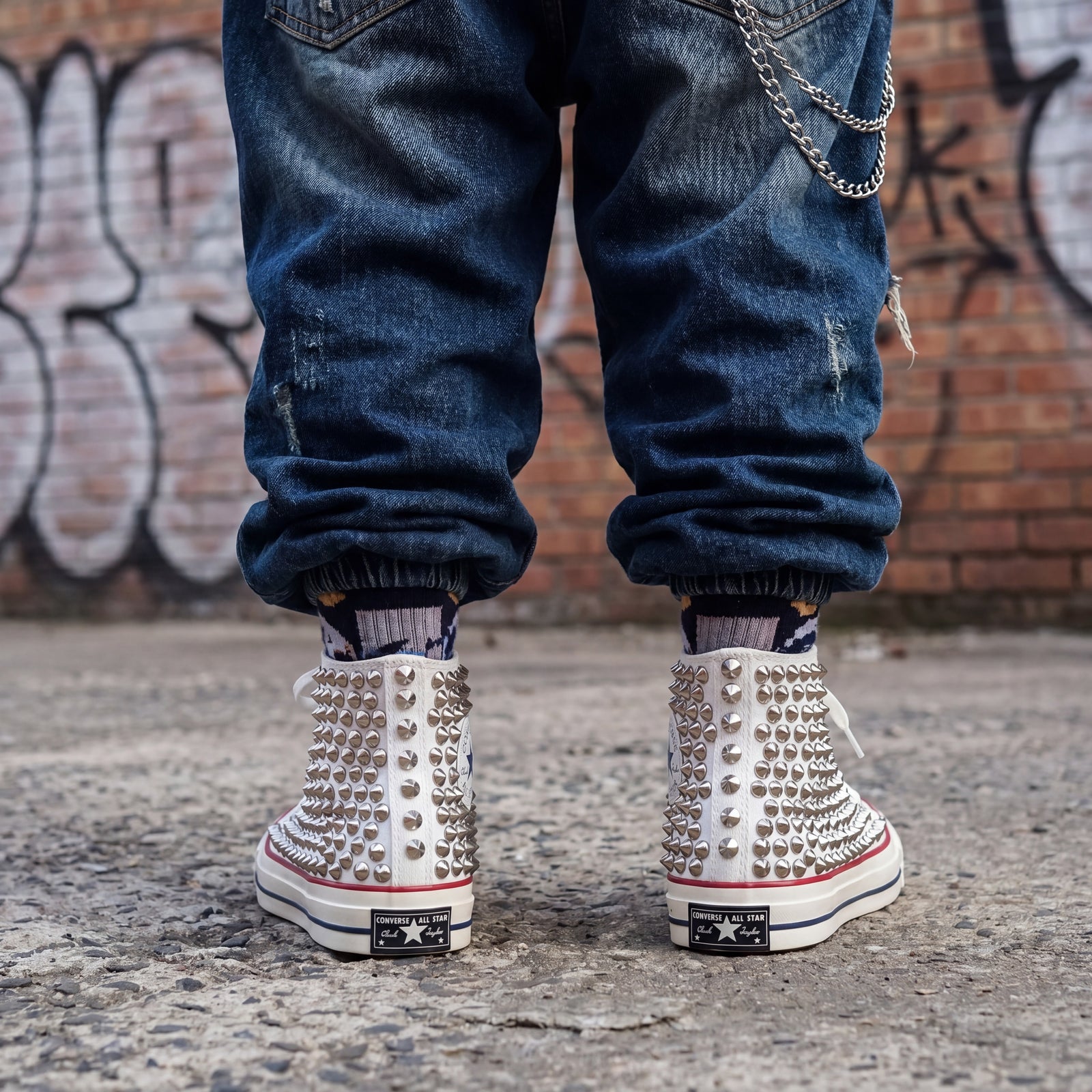 White studded high top Converse sneakers with silver spikes for bold punk streetwear style